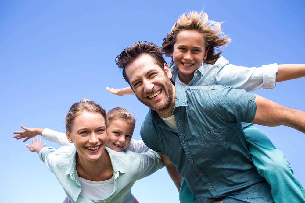 Happy parents with their children in the countryside